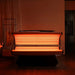 Amber orange LED rows glowing from the open canopy and lower bed of the Galaxy Zero Capsule in a dark room