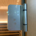 Polished steel hinge holding the tempered glass door on the Blisspod Bergen Sauna Pod cabinet frame