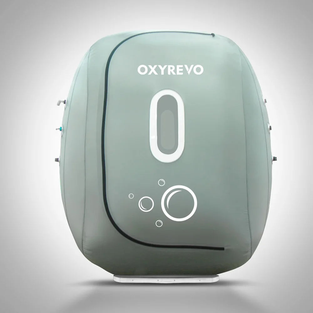 Front elevation of the zipped grey Oxyrevo Heal 40 Oxygen Chamber showing its oval window and bubble logo