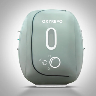 Front elevation of the zipped grey Oxyrevo Heal 40 Oxygen Chamber showing its oval window and bubble logo
