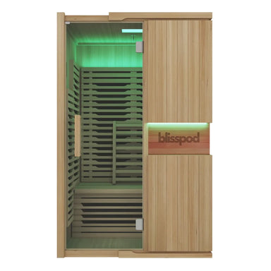 Front view of the closed glass door and green lit interior of the Blisspod Milano Infrared Sauna