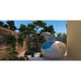 Dreampod Home Float Plus Sensory Deprivation Tank open on a paved terrace with wooden slat fencing