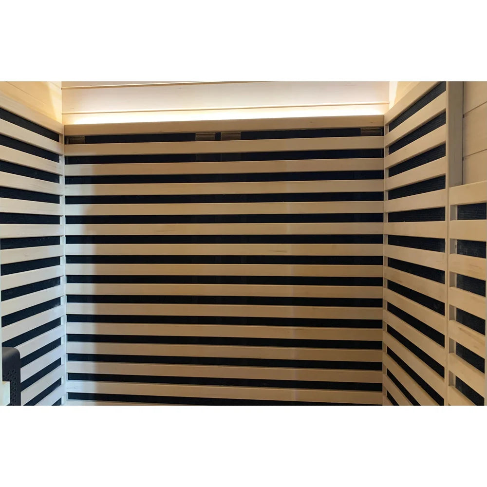 Rows of black heaters across three interior walls below the ceiling light of the Blisspod Bergen Sauna