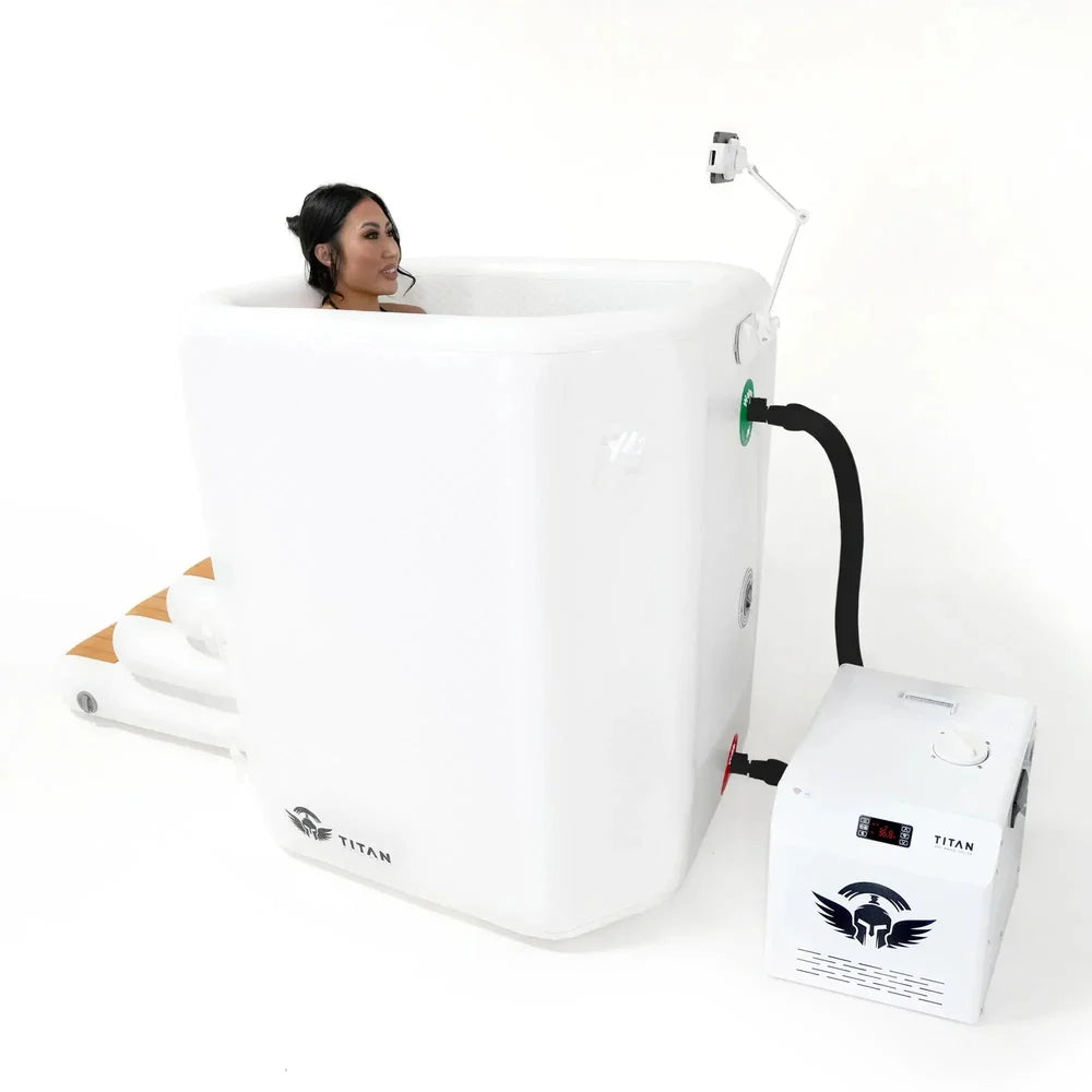 Woman soaking in the Arctic White Titan Atlas tub with phone holder arm and white chiller connected