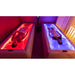 Two people relaxing side by side on a Tsb360 Dry Float Therapy Bed pair glowing red and blue in a dim spa room