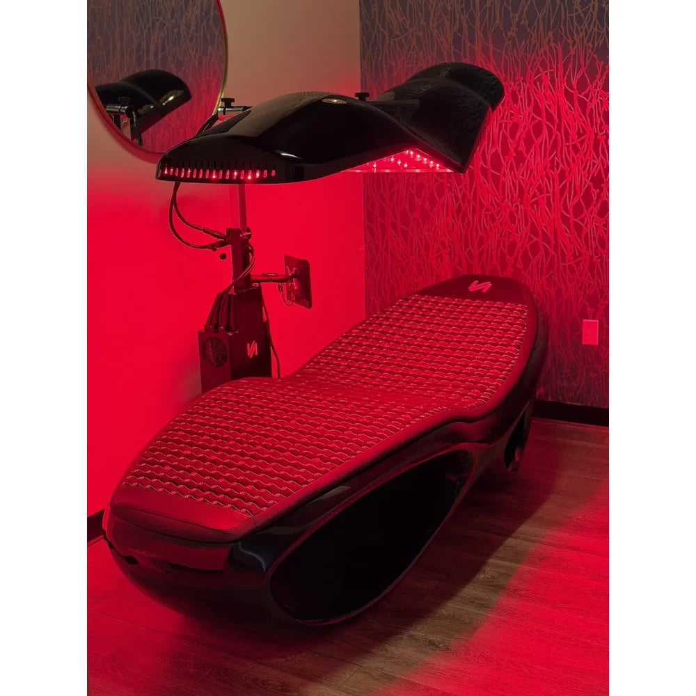 Longevity Longevity Bed installed in a spa room with lit canopy panel, control column and quilted pad