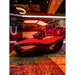 Side profile view of the Tsb360 Longevity Bed Therapy & Recovery Bed in a showroom booth with glowing red canopy