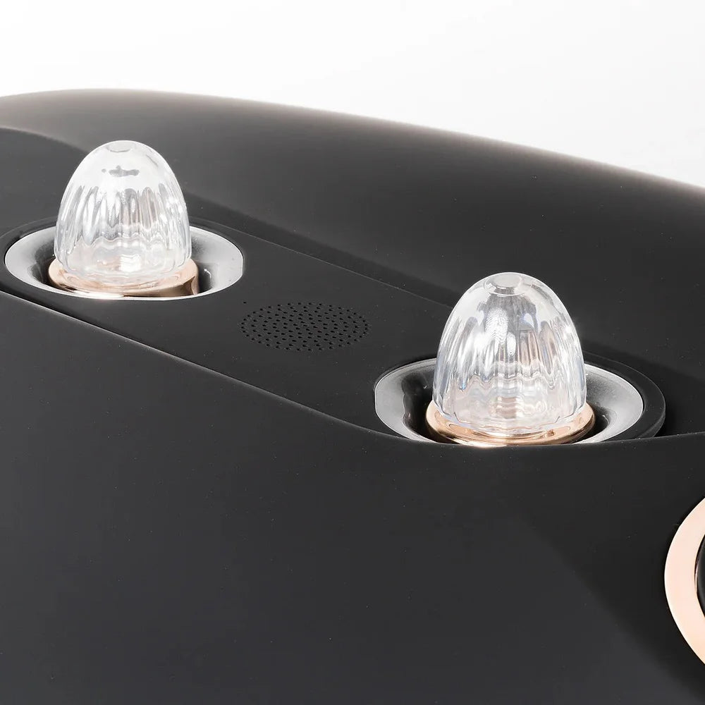 Two clear ribbed mist nozzles and speaker grille on the matte black shell of the Galaxy Zero Atlas Touchscreen LED Therapy unit