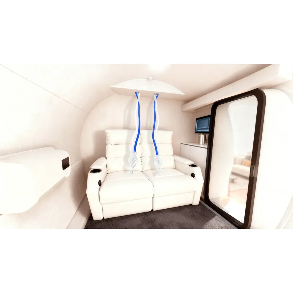 Two-seat recliner and hanging BIBS hoses inside the TwinForce 2.0 ATA Hyperbaric Chamber with Red Light Therapy