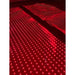 Two side-by-side lit panels with long red LED rows on the Kore KoreKapsule Near Infrared Light Therapy Device in the dark