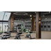 Modern gym floor with benches and weights, a fitness club setting for the Vacu Activ Cryo Flow Local Cryotherapy Unit