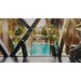 Hotel gym overlooking a resort pool, a hospitality venue suited to the Vacu Activ Cryo Flow Cryotherapy Device