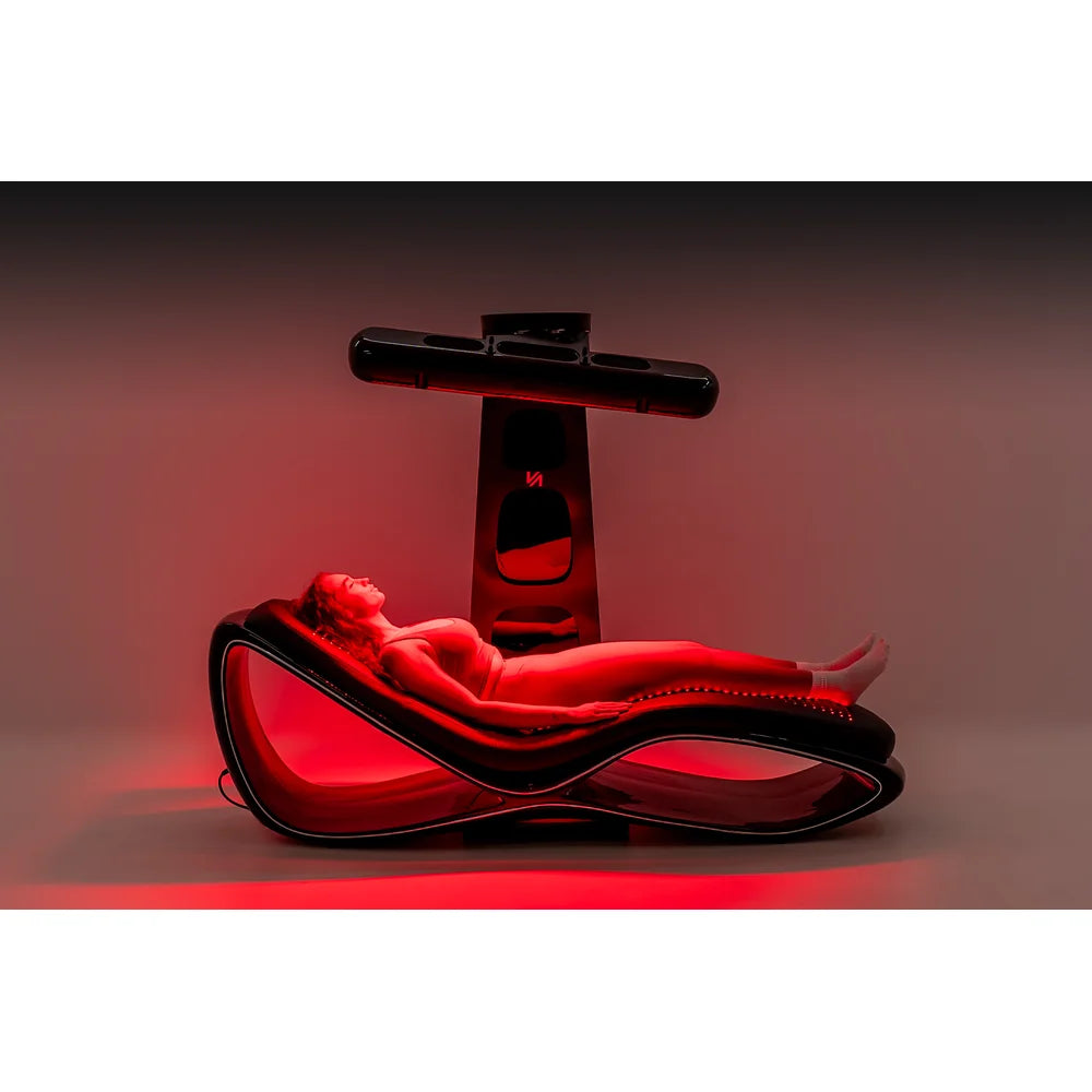 Whole-system side view of the Vacu Activ Red Couch 360 during a session with mattress and lamp lights on