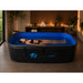 Woman floating on her back in the blue-lined water of the Dreampod Home Float FLEX Float Pod in a home spa room