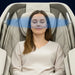 Blue air waves around the headrest as a woman rests in the Infinity Celebrity Elite Recliner ionizer demo