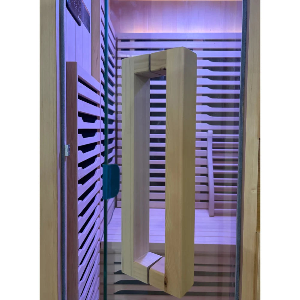 Glass door and wood pull handle of the Blisspod Milano Infrared Sauna with violet chromotherapy light inside