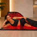 Woman relaxing on the ZAQ Alya red light therapy blanket